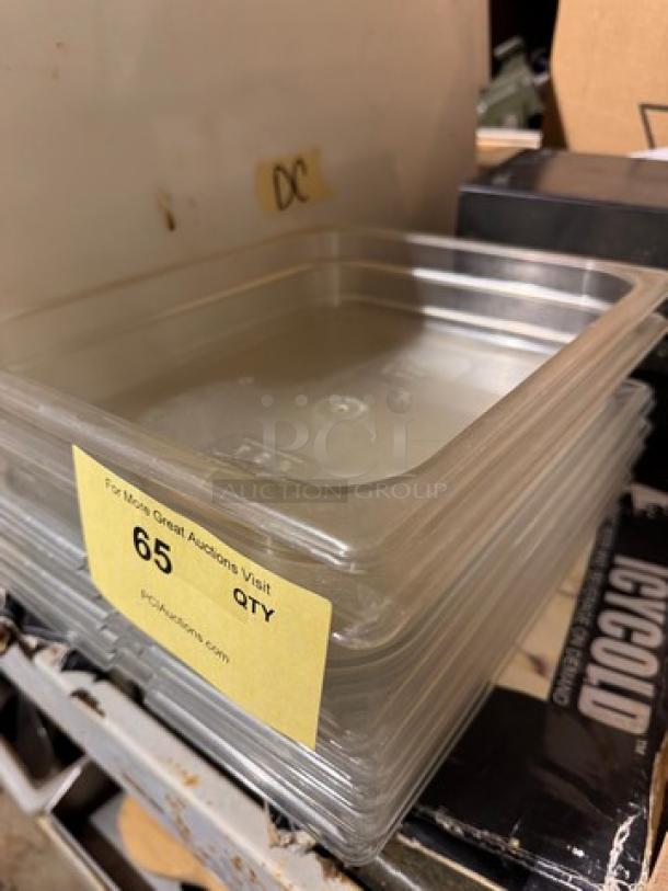 Clear plastic food pan, 1/2x2.5 in, stack of multiple pans. Visible label: "65 QTY." Suitable for kitchen storage.