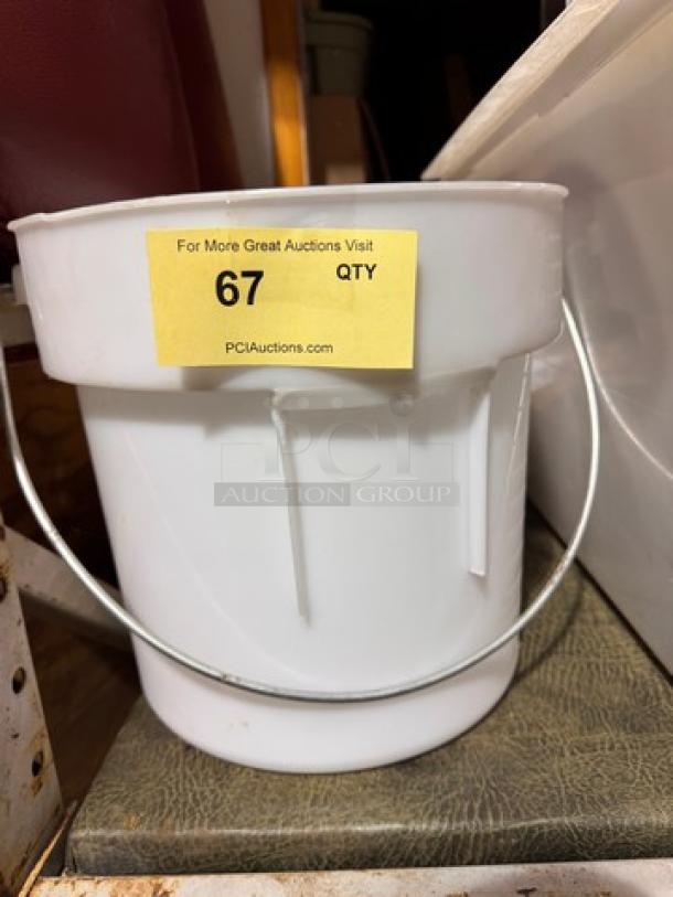 White plastic bucket with a metal handle, in good condition. Label reads "67 QTY" and "PCIAuctions.com".