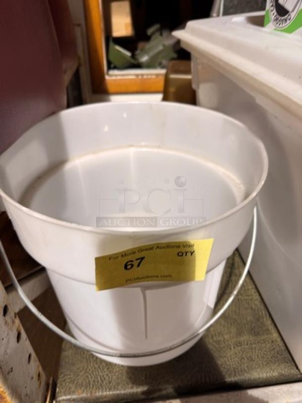 White plastic bucket with handle, labeled "67" for auction, in good condition.