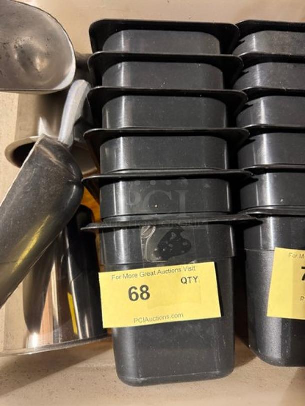 Stack of black 1/6x6IN food pans in good condition. Yellow label shows quantity as 68.