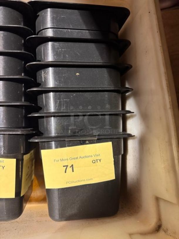 Stack of black 1/6x6IN food pans, model BIDX6, in good condition with auction label displaying "71 QTY."