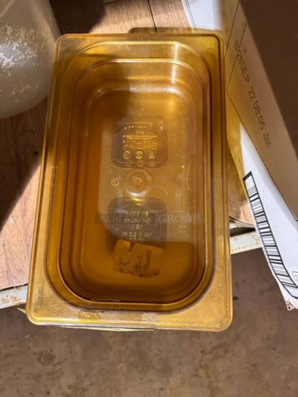 1/4x2.5IN BIDX4 amber food pan, used, clear measurement markings, durable plastic, ideal for commercial kitchen use.