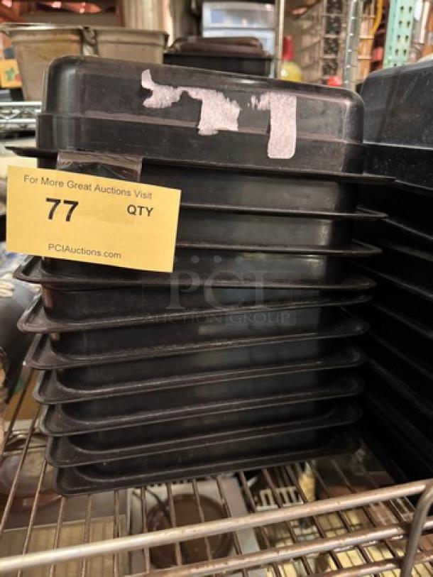 1/2x2.5IN plastic food pan stack, black, BIDX10, used condition. Quantity tag marked "77" from PCI Auctions.