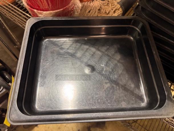 Black plastic food pan, size 1/2x2.5 inches, model BIDX10, used condition with visible surface marks.