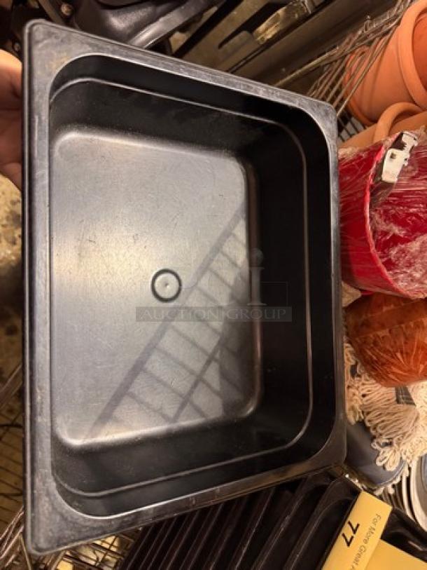 Black 1/2x4IN food pan BIDX7, rectangular, in good condition, ideal for kitchen use, no visible markings.