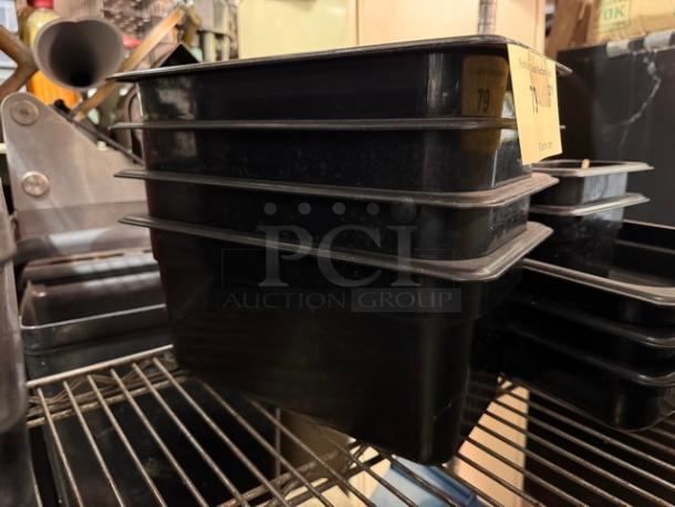Black 1/3X6IN food pan, stackable, durable plastic, shown in excellent condition. Auction tag indicates BIDX4.