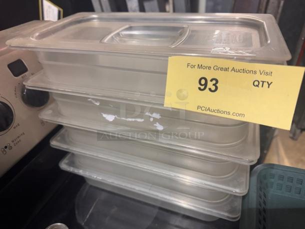 Stack of four 1/3 x 2.5in food pans with lids, clear plastic, light wear. Yellow auction label indicates lot 93.