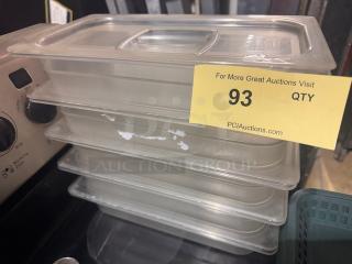 Stack of four 1/3 x 2.5in food pans with lids, clear plastic, light wear. Yellow auction label indicates lot 93.