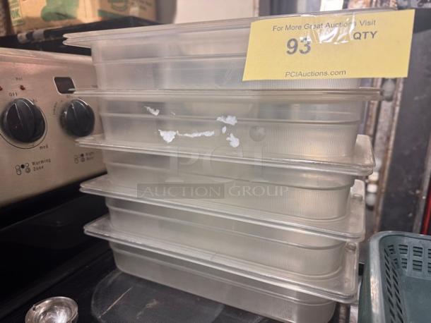 Clear 1/3 x 2.5in food pan with lid, stack of five. Appears used, mild scratches. Auction tag reads "93," from PCIAuctions.com.