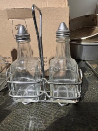 3-piece oil & vinegar cruet set with metal rack; clear glass bottles, metal caps, used condition.