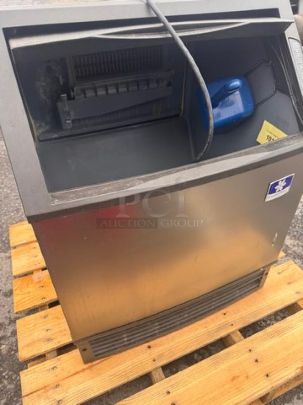 Manitowoc UYF014A-161B Icemaker, 115V, stainless steel, visible wear, on wooden pallet, model label on front.