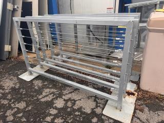 Metal cable railing/fence BIDX5, gray finish, sturdy frame, cables evenly spaced. Used condition, minor rust visible. Ideal for outdoor use.