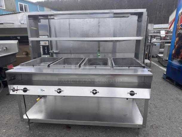 VOLLRATH 4 Bay steam table with overhead shelf, model 38004, 120V. Notable dent on one side. 