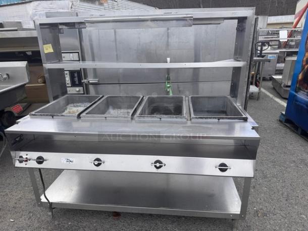 VOLLRATH 4 Bay steam table, model 38004, with overhead shelf, 120V, visible side dent, stainless steel, used condition.