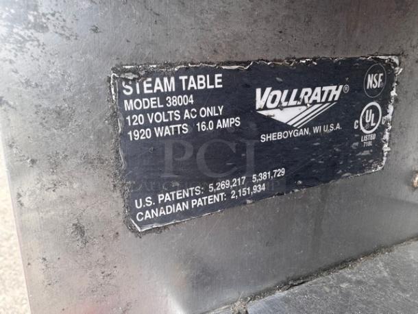 VOLLRATH 4 Bay Steam Table Model 38004, 120V, 1920W, with overhead shelf, visible dent on one side, patent info shown.