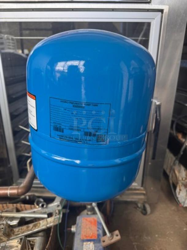 Blue HYDRO-PNEUMATIC PUMP TANK, model V15P 100, with visible labeling and warning tag. Appears in good condition.