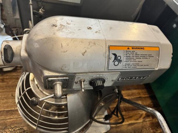 HOBART A200 20Qt commercial mixer with attachments, features speed dial, visible warning label, used condition.