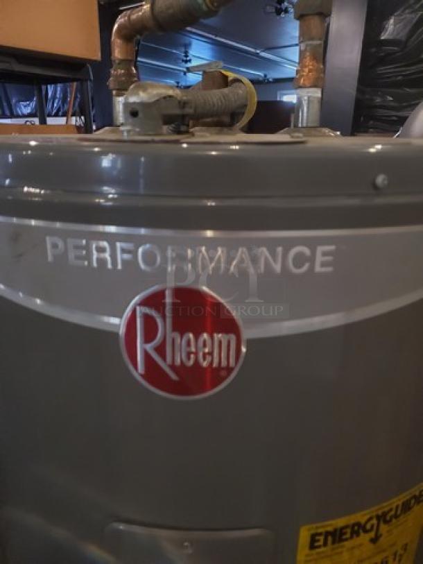 Rheem Performance 50 Gal. 4500-Watt electric water heater, gray, with visible brand logo and EnergyGuide label.