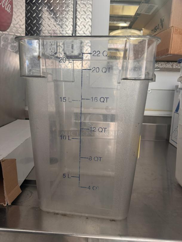 Clear 22QT storage food container with measurement markings, used condition, square shape, suitable for kitchen storage.