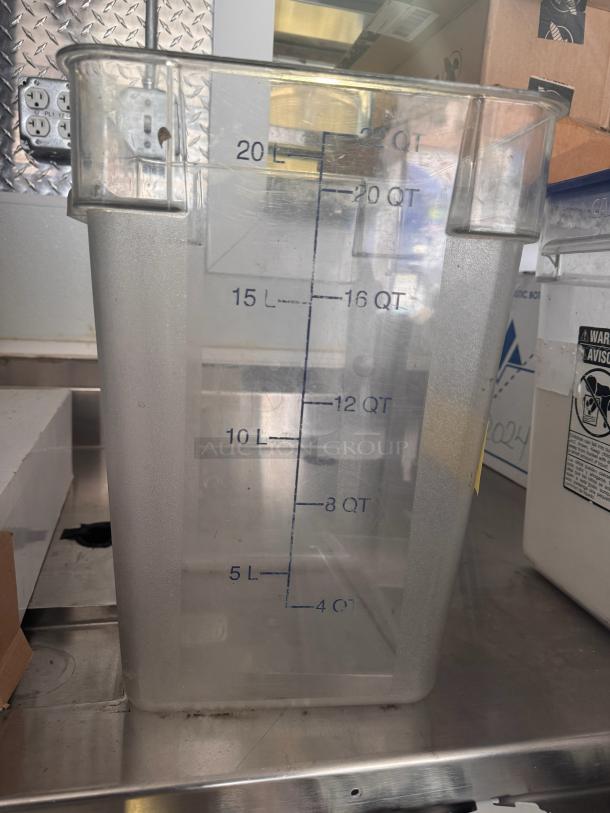 Clear 22QT storage food container with blue measurement markings, showing capacity in quarts and liters. Used condition.