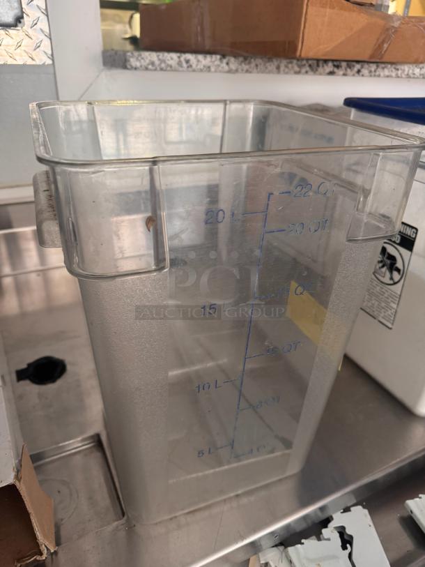 Clear 22QT food storage container with blue measurement markings, gently used condition.
