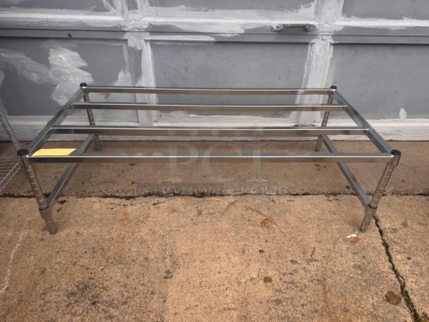 Stainless steel dunnage rack, rectangular, sturdy construction, used condition, suitable for storage and organization.