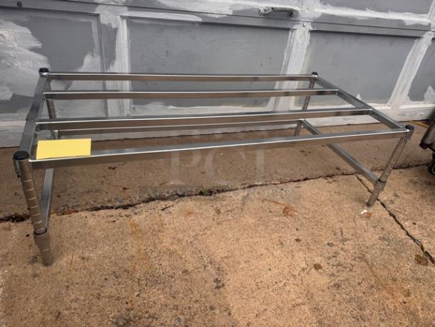 Stainless steel dunnage rack in good condition, featuring a sturdy frame, ideal for storage.