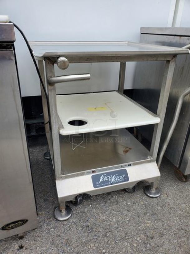 Slicer stand/work table with stainless steel frame, cutting surface, and lower shelf. Features a "SliceFace" label. Good condition.