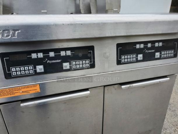 Frymaster FMPH355BLSC NG Fryer, stainless steel, dual digital control panels, visible wear, label with safety instructions.