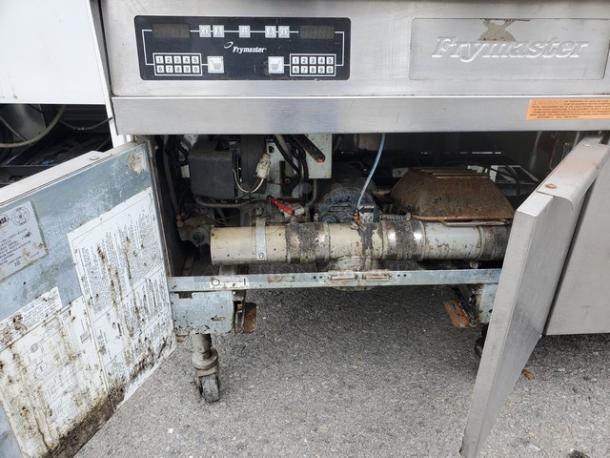 Frymaster FMPH355BLSC NG Fryer, stainless steel, visible control panel, open compartment showing interior mechanics, signs of use.