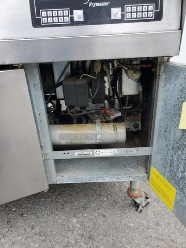 Frymaster FMPH355BLSC NG fryer, open compartment showing internal components, mild wear, stainless steel exterior.