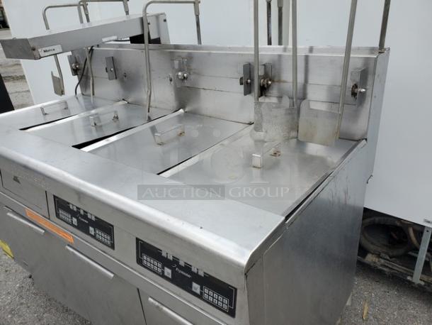 Frymaster FMPH355BLSC NG Fryer, stainless steel, three baskets, digital controls, visible wear, suitable for commercial use.