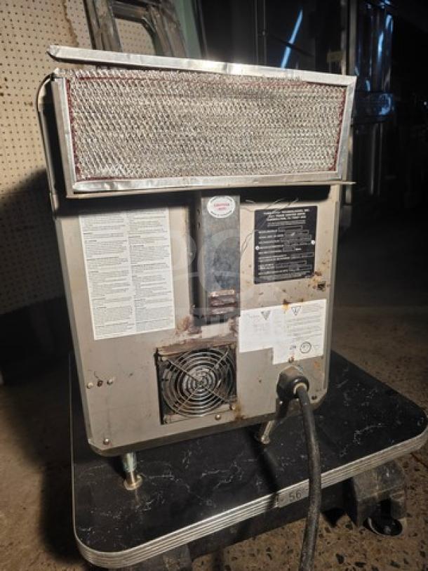 Turbochef NGO High Speed Countertop Oven, visible wear, model and safety labels, rear view with power cord.