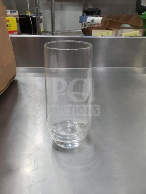 Clear Tall Hi-Ball Glass BIDX20, cylindrical shape, excellent condition, placed on a stainless steel surface.
