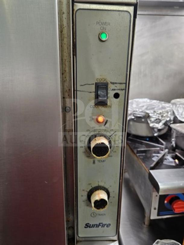 Sunfire full-size single deck convection oven control panel, worn knobs, status lights, cooking function settings visible.