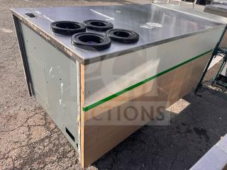 Commercial metal and wood stand with a stainless steel top, featuring four cup dispensers. Moderate wear visible on surfaces.