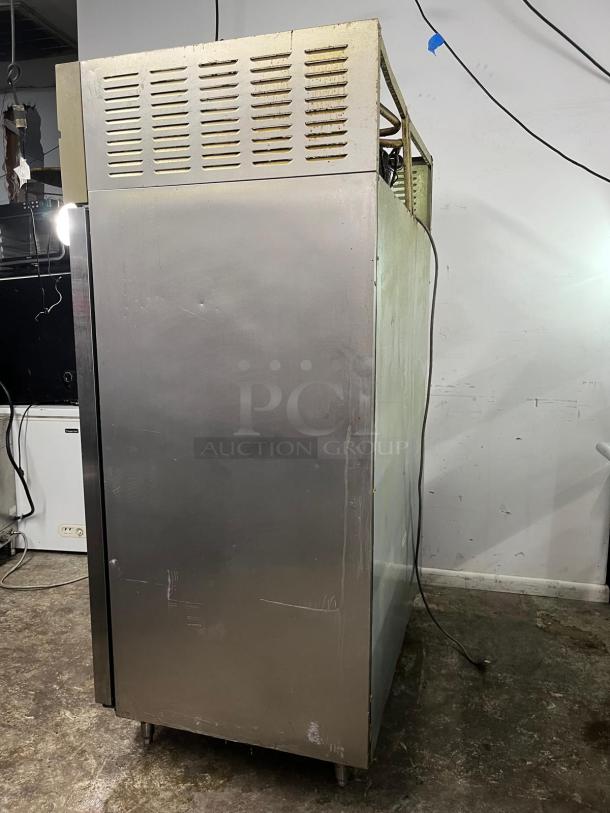 Green World Turbo Air GST-40DR commercial refrigerator, two solid doors, stainless steel, visible wear, power cord attached.