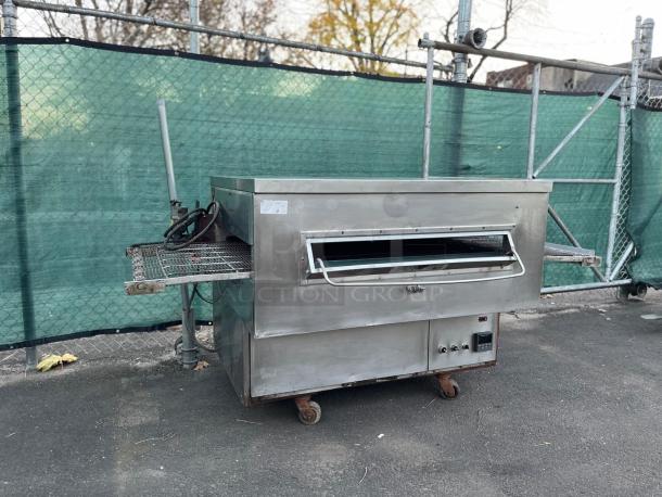 Middleby Marshall PS360G gas-fired impingement conveyor oven, stainless steel, on casters, outdoor setting, used condition.