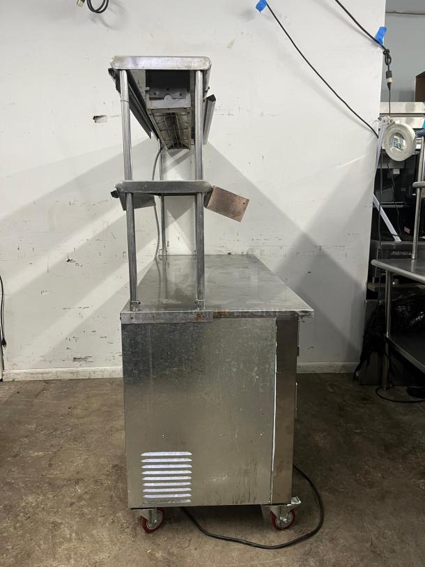 LEADER LB48 under counter refrigerator with two full and one half door, double shelves, and heat lamp. Stainless steel, fair condition.