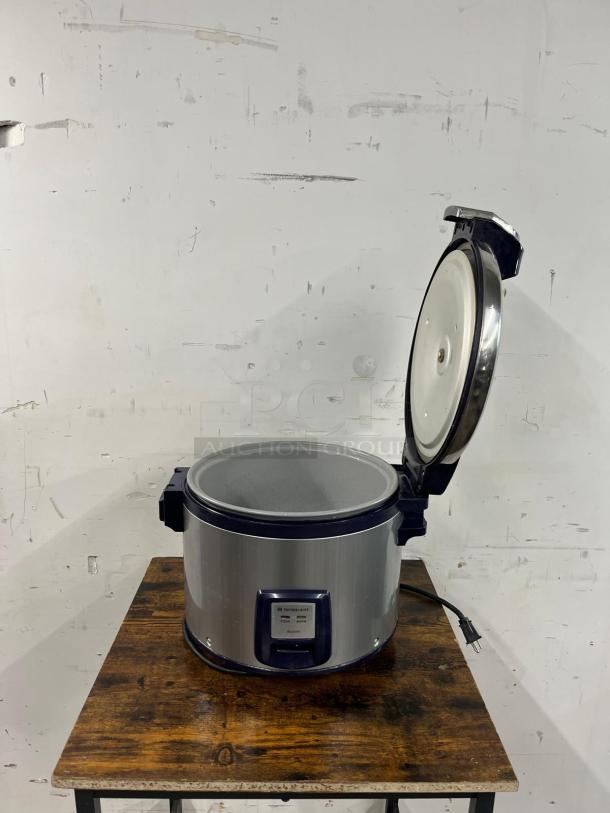 Thunder Group SEJ3201 30-cup rice cooker, stainless steel, NSF/ETL certified, lid open, on a wooden table.