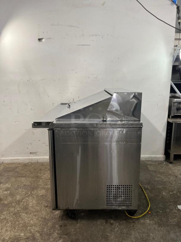 Turbo Air MST-48-18-N 48in Sandwich Salad Prep Cooler, visible wear, made of stainless steel, accommodates 18 pans.