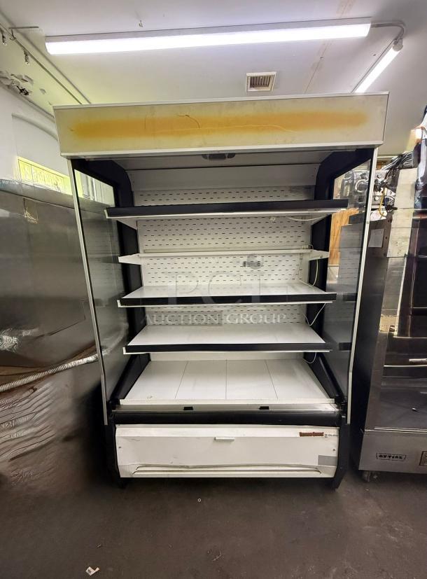 Universal Coolers open-air merchandiser, commercial cooler with multiple shelves, used condition, visible wear on top.