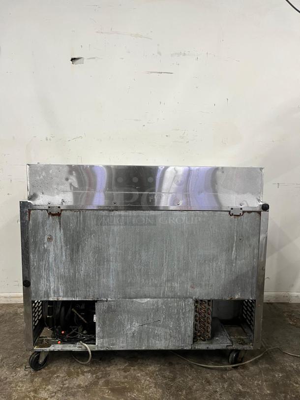 Turbo Air MST-48 M3 Series 48in Sandwich/Salad Prep Table, visible wear, stainless steel, on casters.