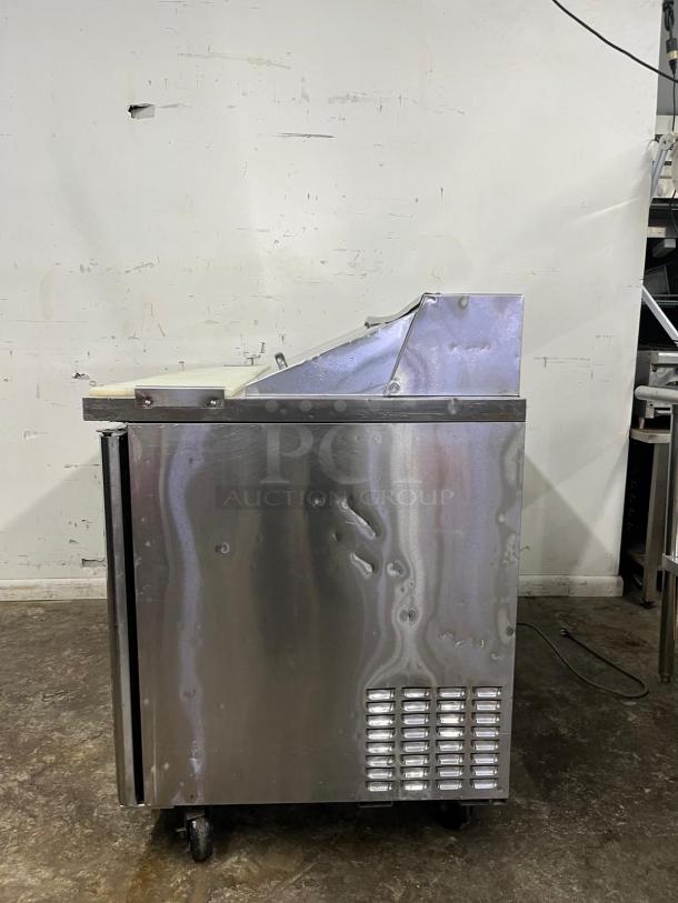 Turbo Air MST-48 M3 Series 48in sandwich prep table, stainless steel, on casters, minor surface wear.