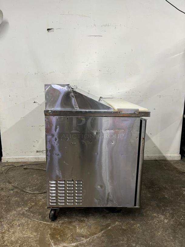 Turbo Air MST-48 M3 Series 48in sandwich/salad prep table, stainless steel, visible wear, mounted on casters.