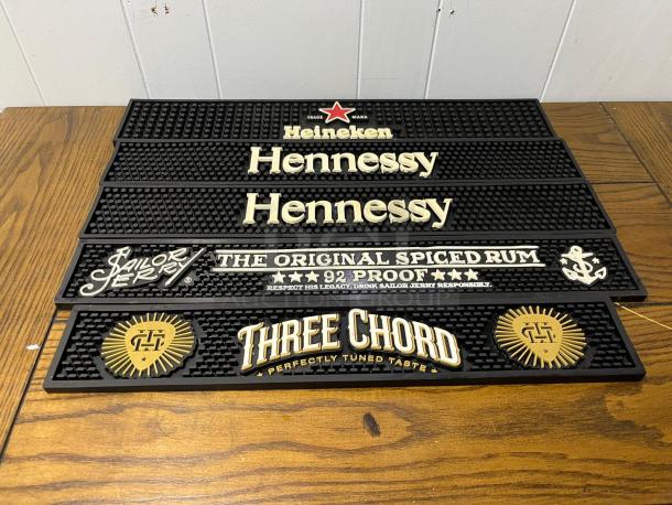 Set of bar runners featuring logos: Heineken, Hennessy, Sailor Jerry, and Three Chord. Excellent condition, rubber material.