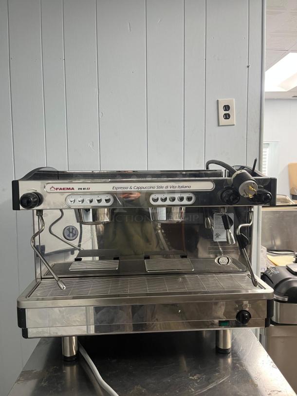 FAEMA E98 RE espresso machine in excellent condition, featuring dual group heads, stainless steel finish, and user-friendly controls.