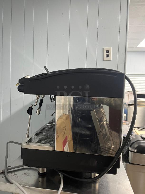 FAEMA E98 RE espresso machine, sleek design, late model, features dual steam wands, in good condition, reflective side panel.