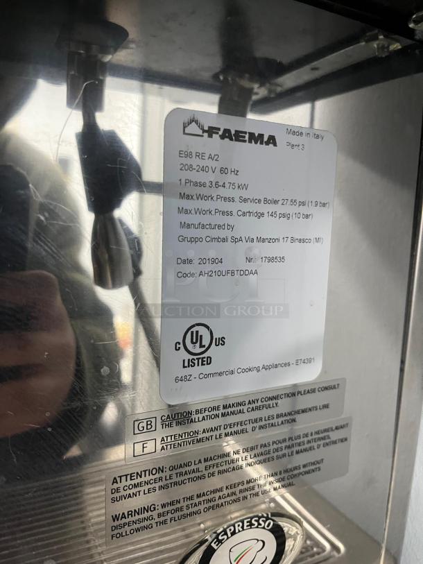FAEMA E98 RE espresso machine tag showing model, voltage, and safety warnings in good condition. Made in Italy.