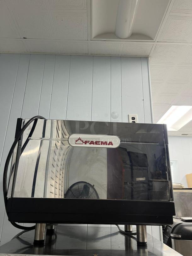 FAEMA E98 RE espresso machine, stainless steel, lightly used, features easy adjustment, visible FAEMA logo.